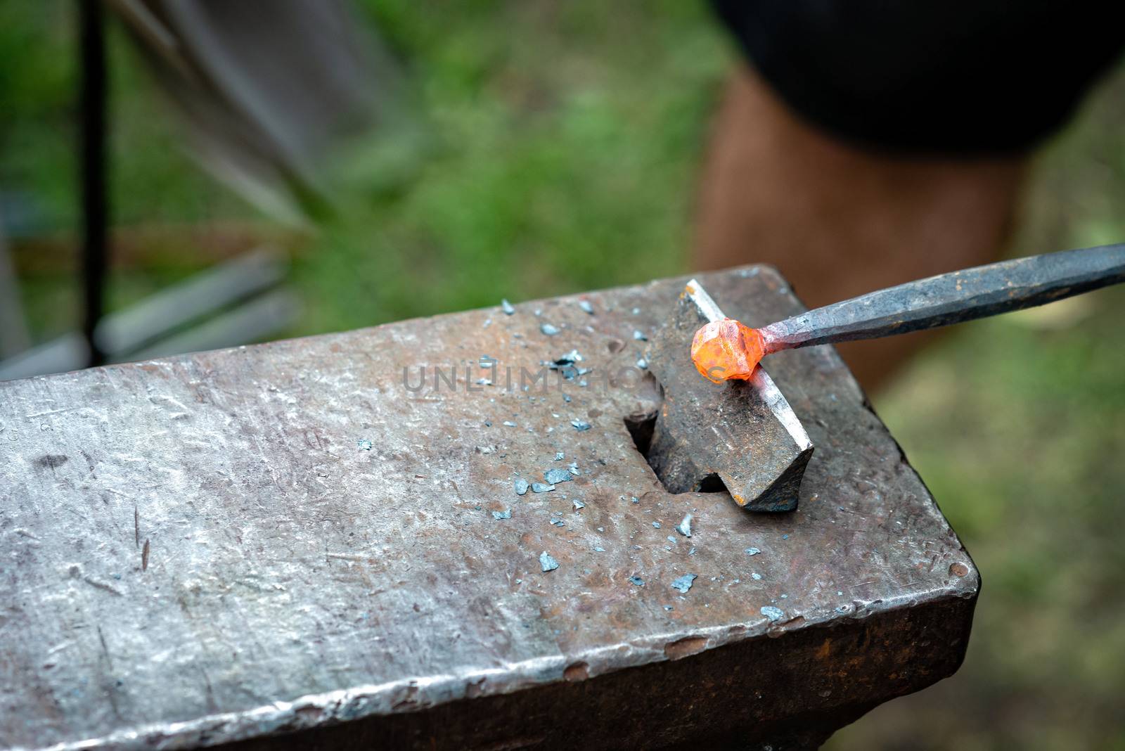 the blacksmith forged a strip of hot metal. close up - Image