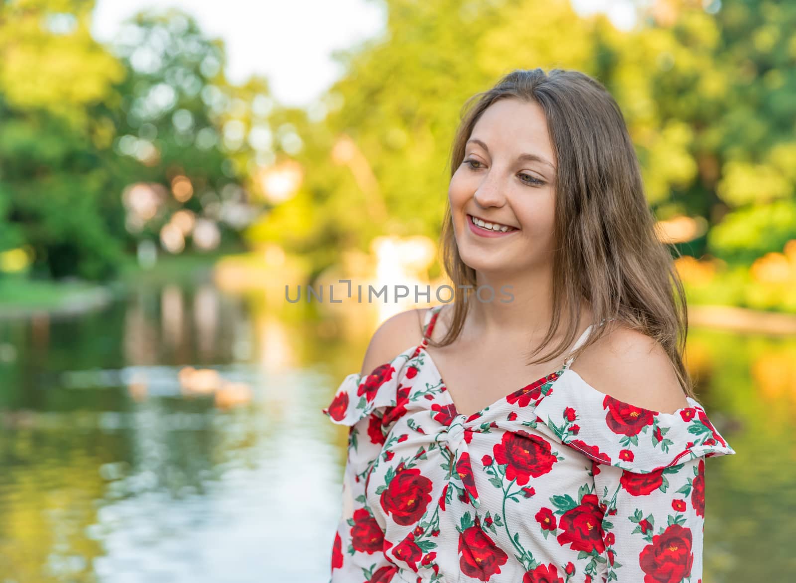 Portrait of a young woman in the park at sunset by Edophoto
