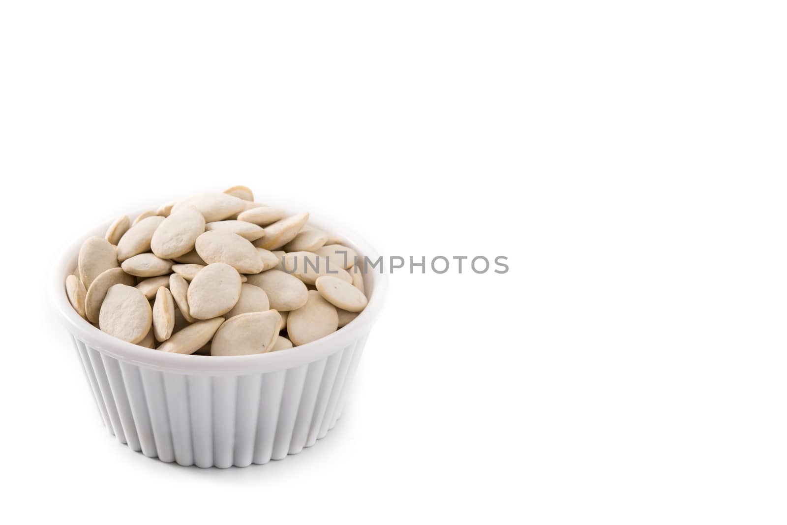Pumpkin seeds in bowl isolated on white background