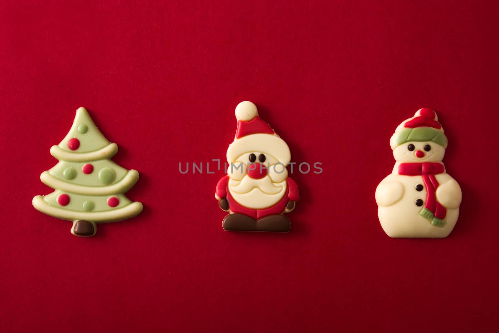 Christmas chocolate bonbons on red background
