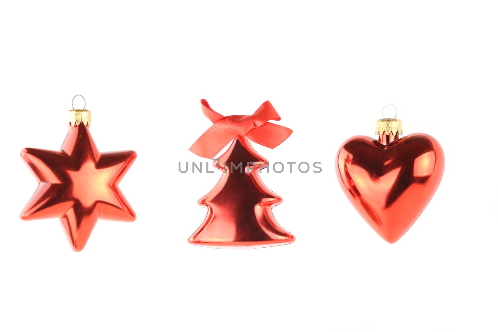 Three hanging red Christmas balls isolated having different shapes: star, heart and tree on white background