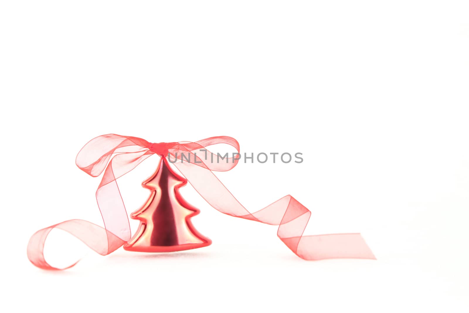 Isolated red Christmas tree bauble with red organza ribbon on wh by robbyfontanesi