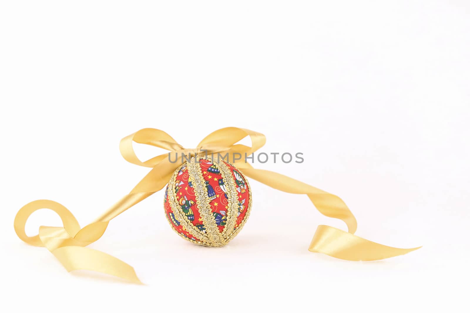 Isolated handmade decoupage Christmas bauble with gold satin flake ribbon on white background by robbyfontanesi