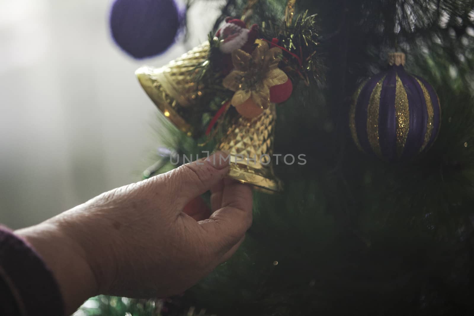 Older woman decorating Christmas tree by snep_photo
