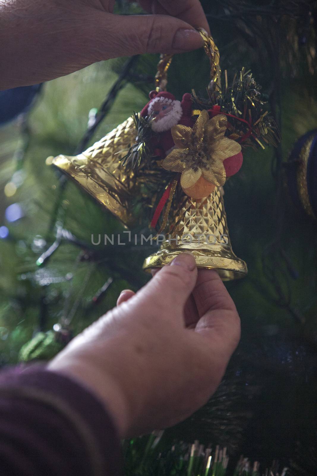 Older woman decorating Christmas tree by snep_photo