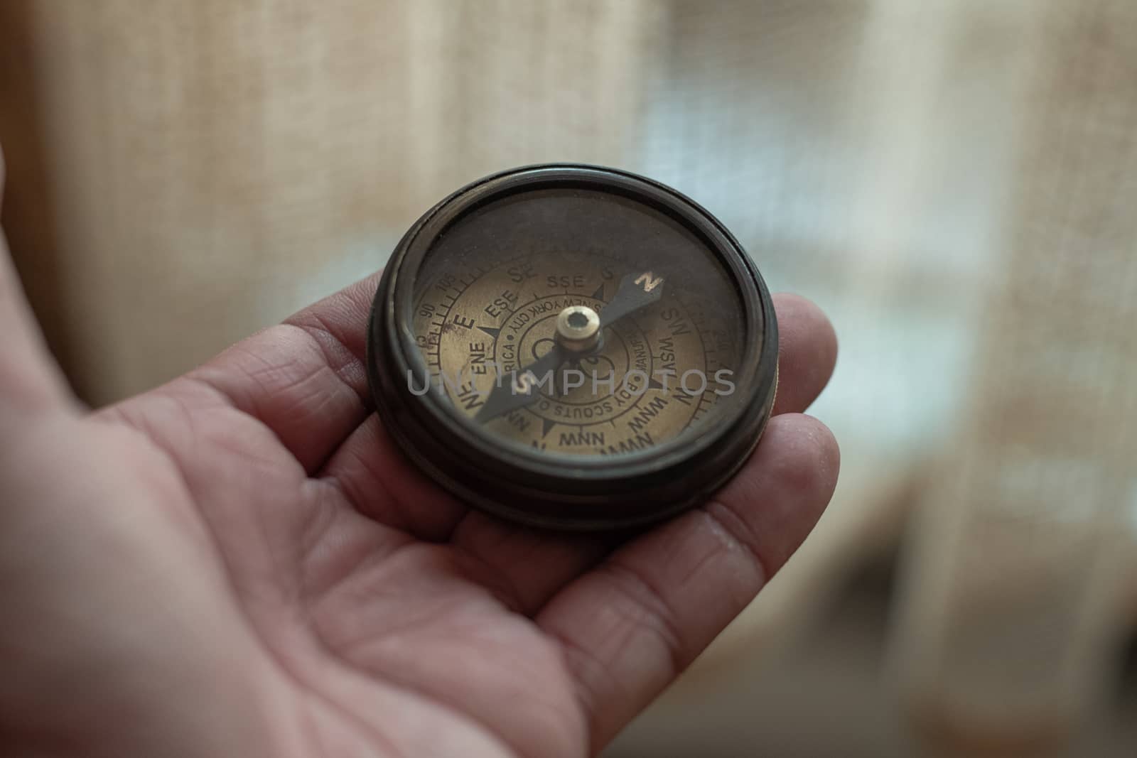 Close-Up Of Hand Holding Navigational Compass