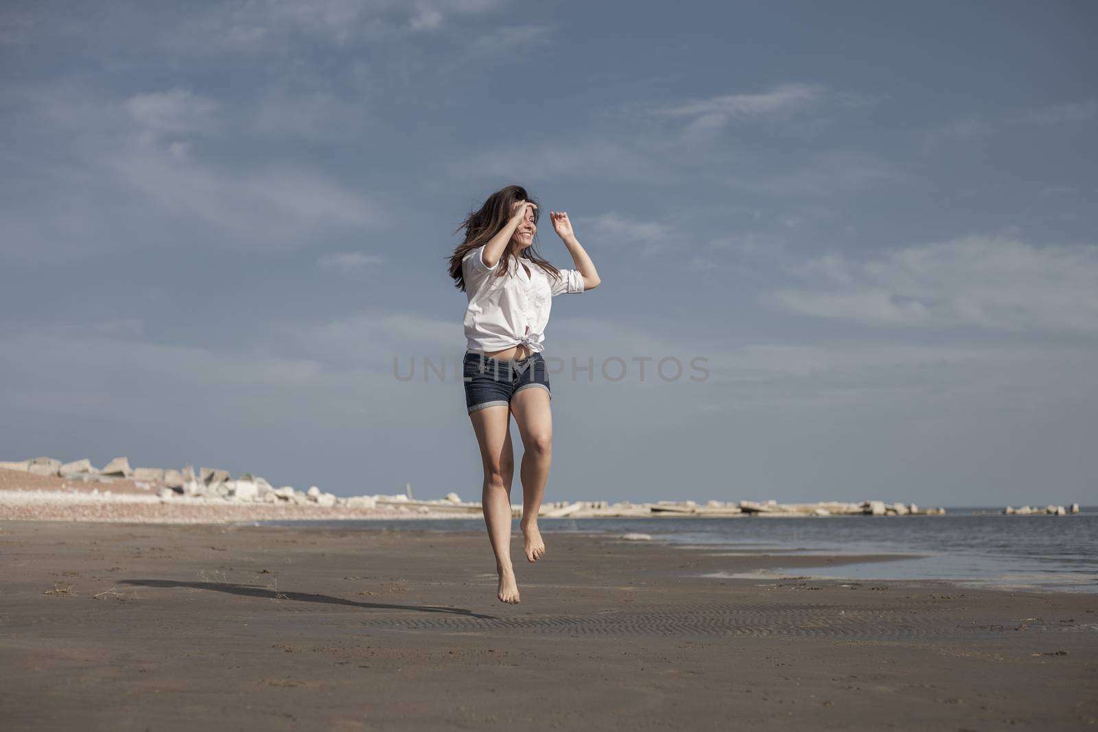 Attractive Girl Jumping on the Beach Having Fun by snep_photo