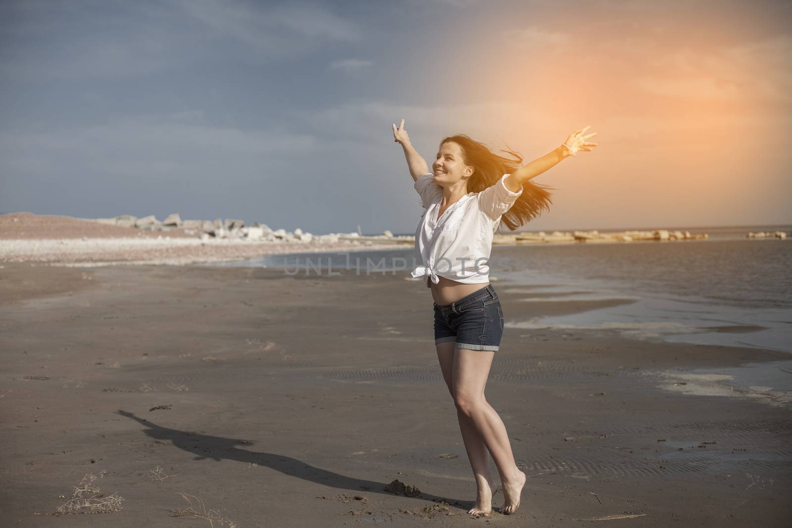 Sexy woman on beach smiling and enjoying a sunny by snep_photo