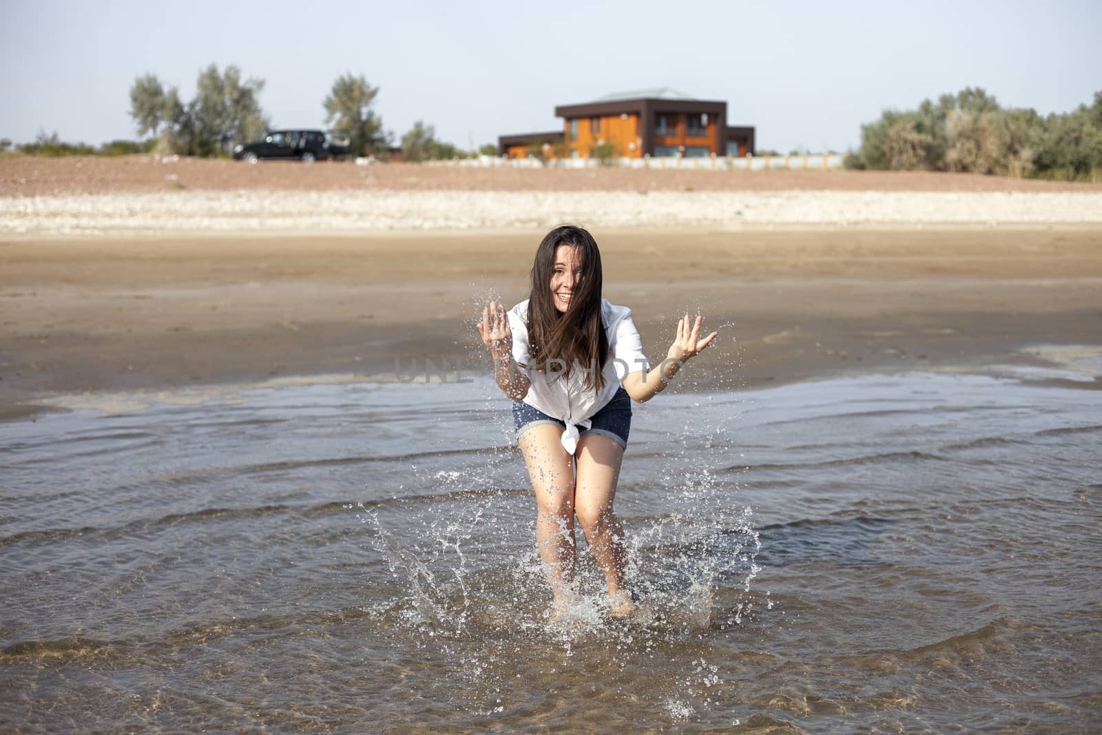 Woman splashing in a sea by snep_photo