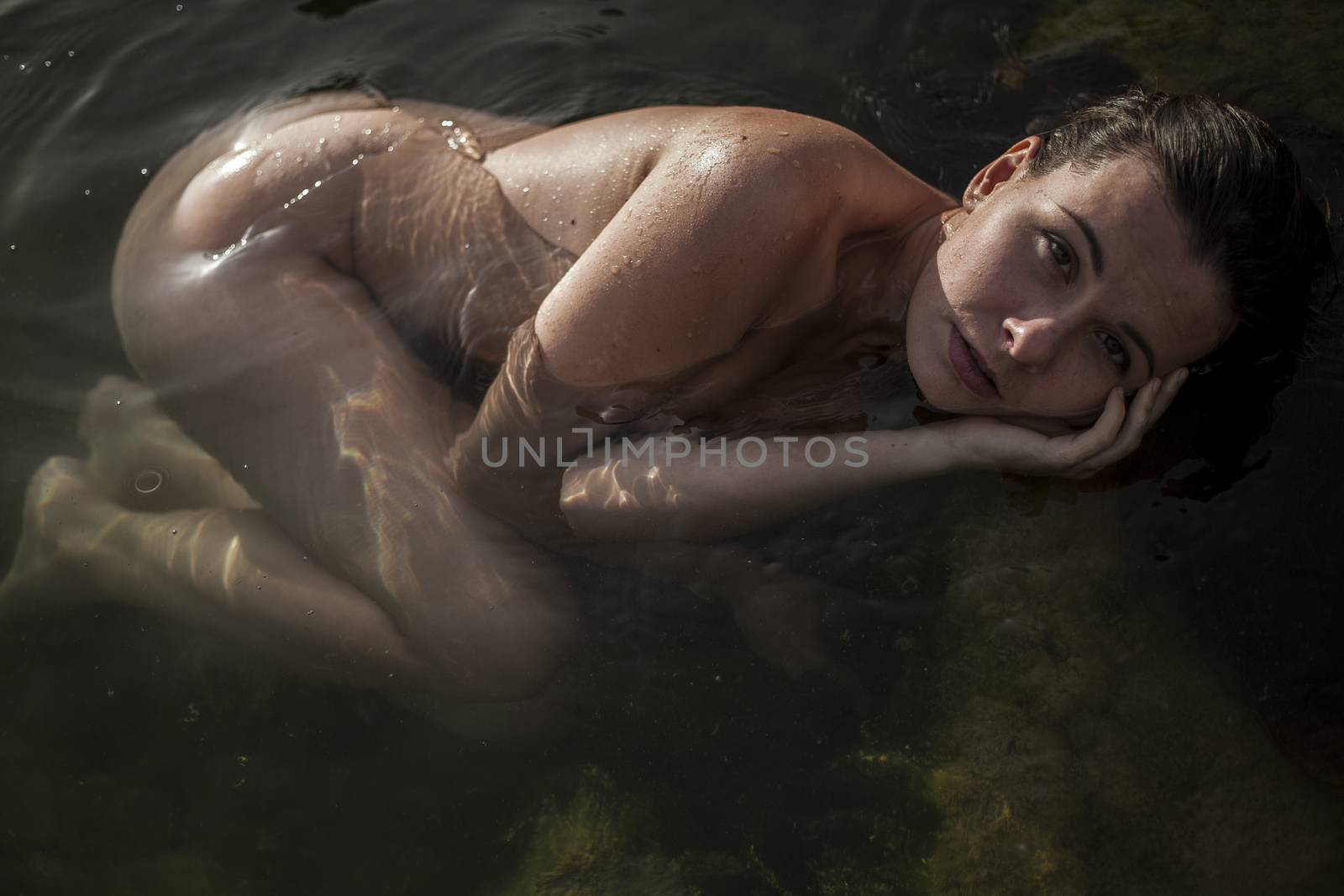 Portrait of beautiful young woman bathing in sea