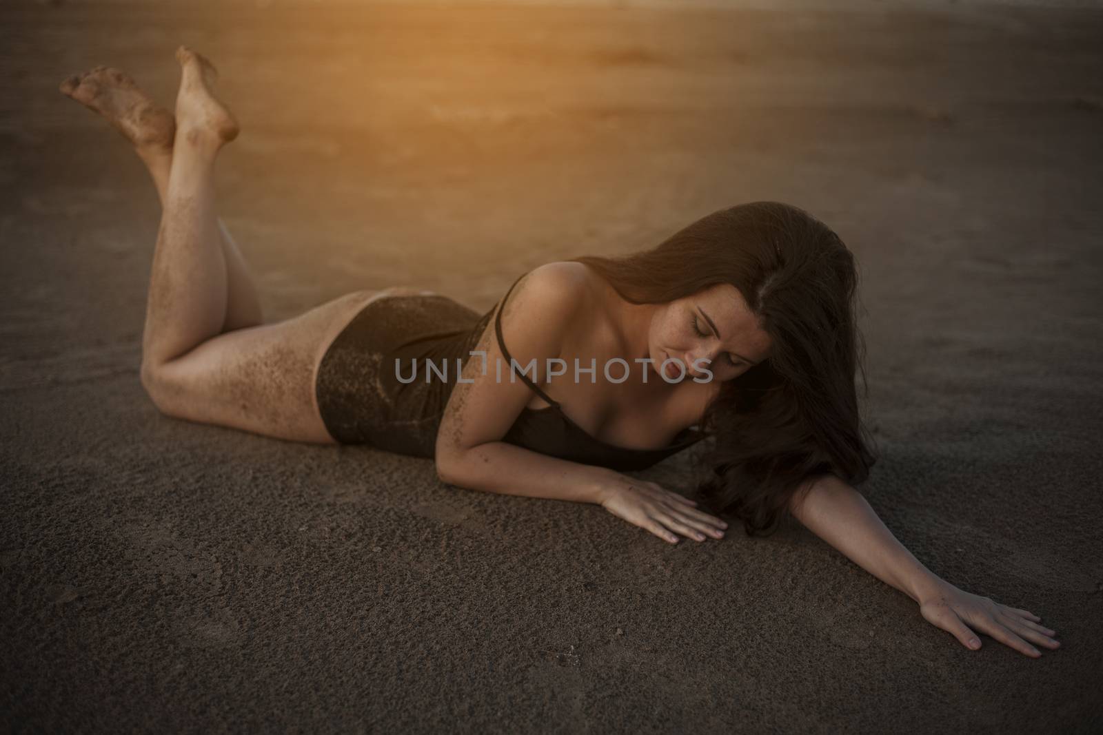 Beautiful topless woman lying in the sand. by snep_photo