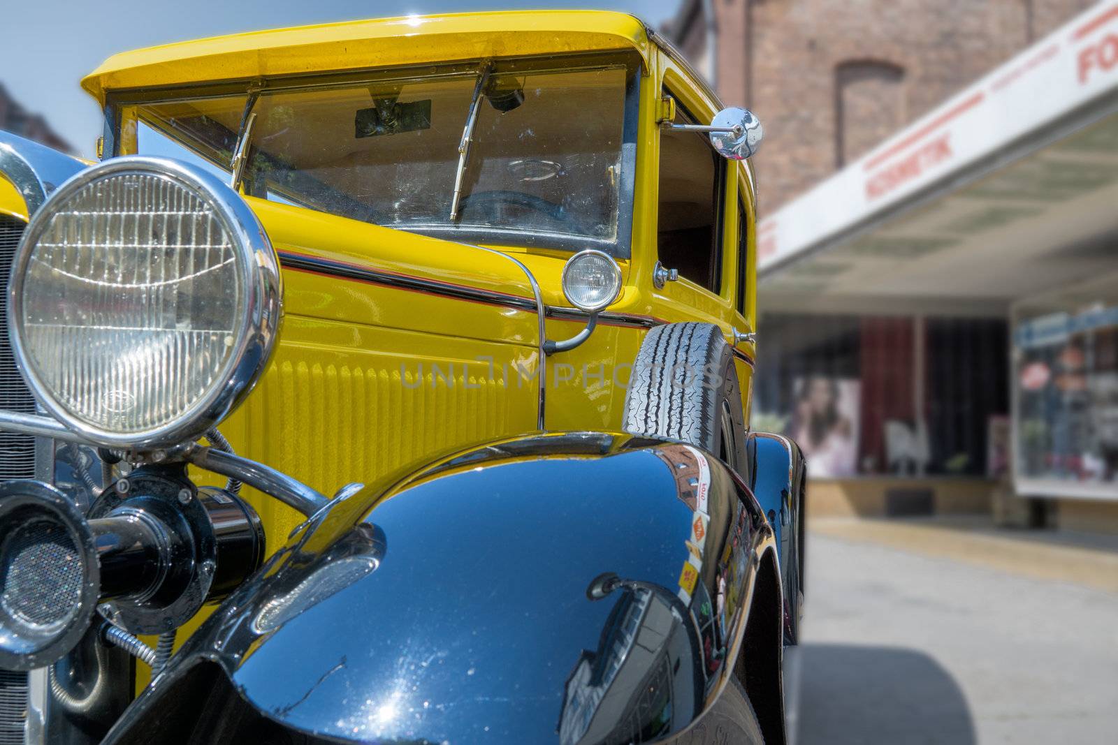 Wolfsburg, Lower Saxony, Germany, May 26., 2018: Yellow historic car in close-up view diagonally from the front, with black fenders, side parts with ventilation slots and small windscreen wipers, Oldtimer Festival, Germany