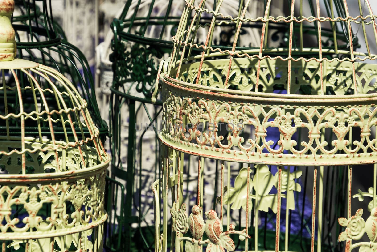 Antique bird cages decorated with ornaments at a flea market, Germany by geogif