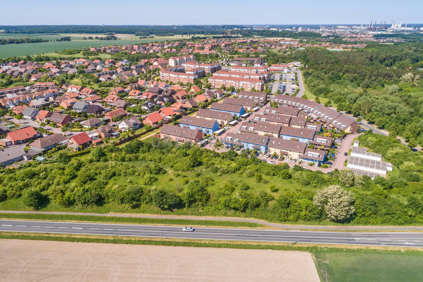 Aerial view of a suburb on the outskirts of Wolfsburg in Germany, with terraced houses, semi-detached houses and detached houses, arable land in the foreground by geogif