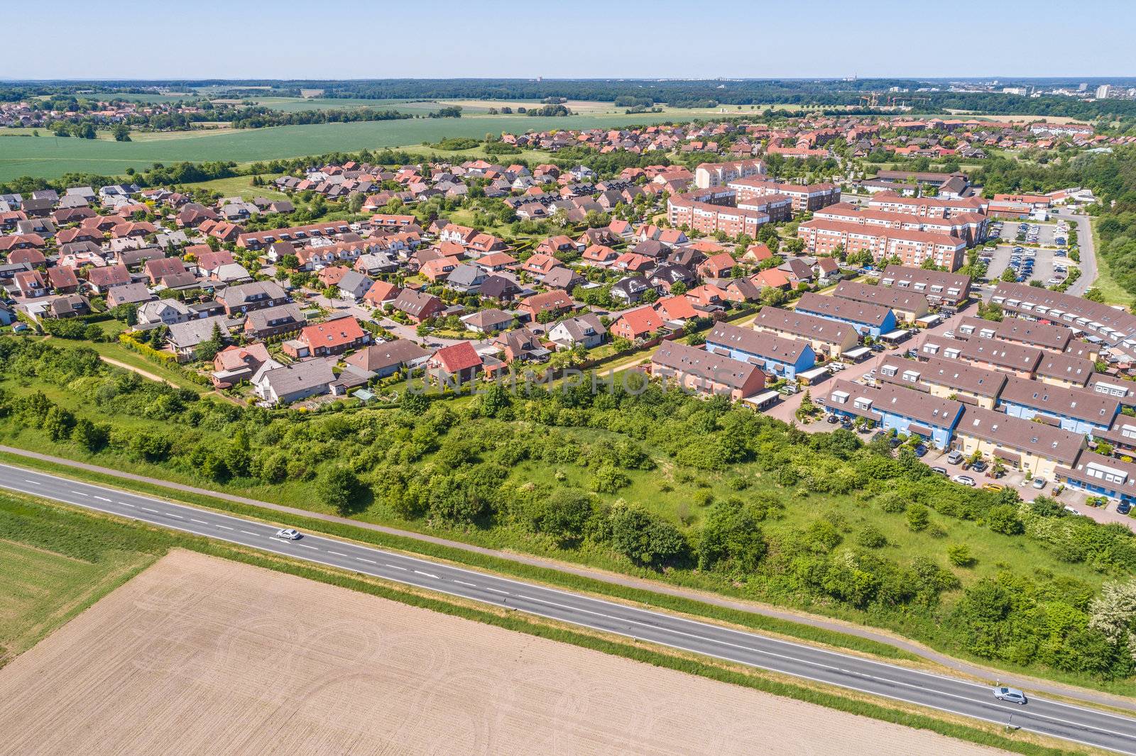 Aerial view of a suburb on the outskirts of Wolfsburg in Germany, with terraced houses, semi-detached houses and detached houses, arable land in the foreground by geogif