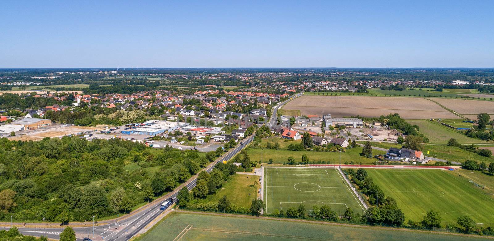 Aerial view of an industrial estate on the outskirts of Wolfsburg, Germany, with a football pitch in the foreground by geogif