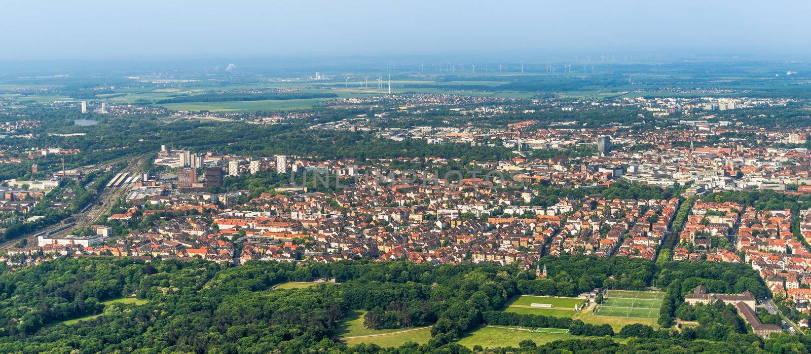 Aerial view of the southern edge of the city of Braunschweig, with parts of the railway station, residential buildings with detached houses, terraced houses and high-rise buildings. by geogif