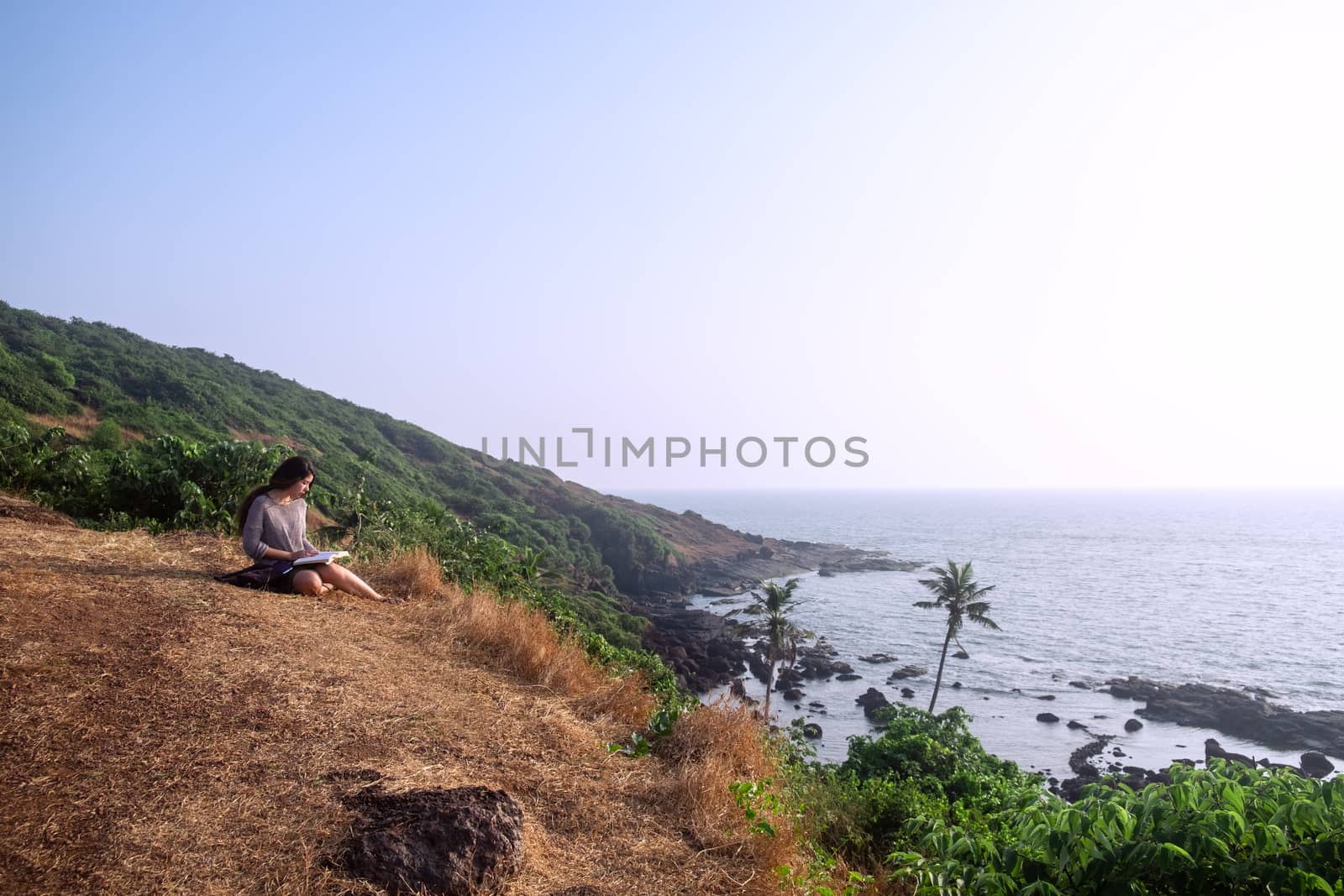 One asian woman and a book with sea view by snep_photo