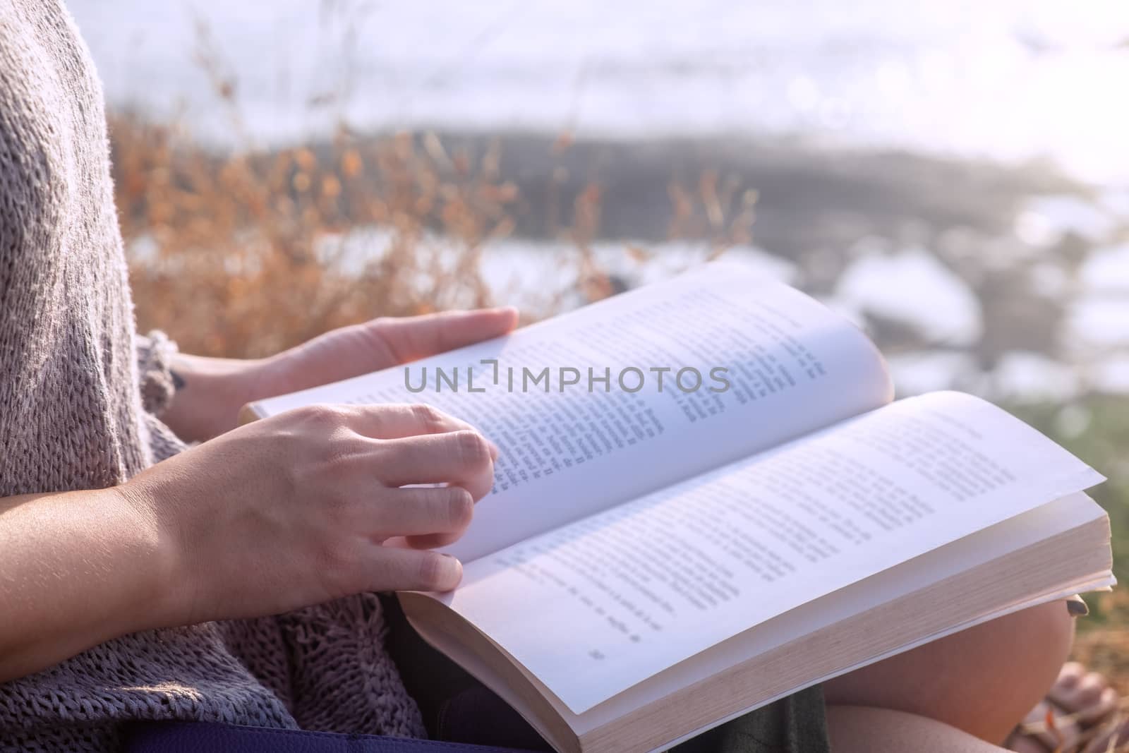 Young Woman Reading Book close-up by snep_photo
