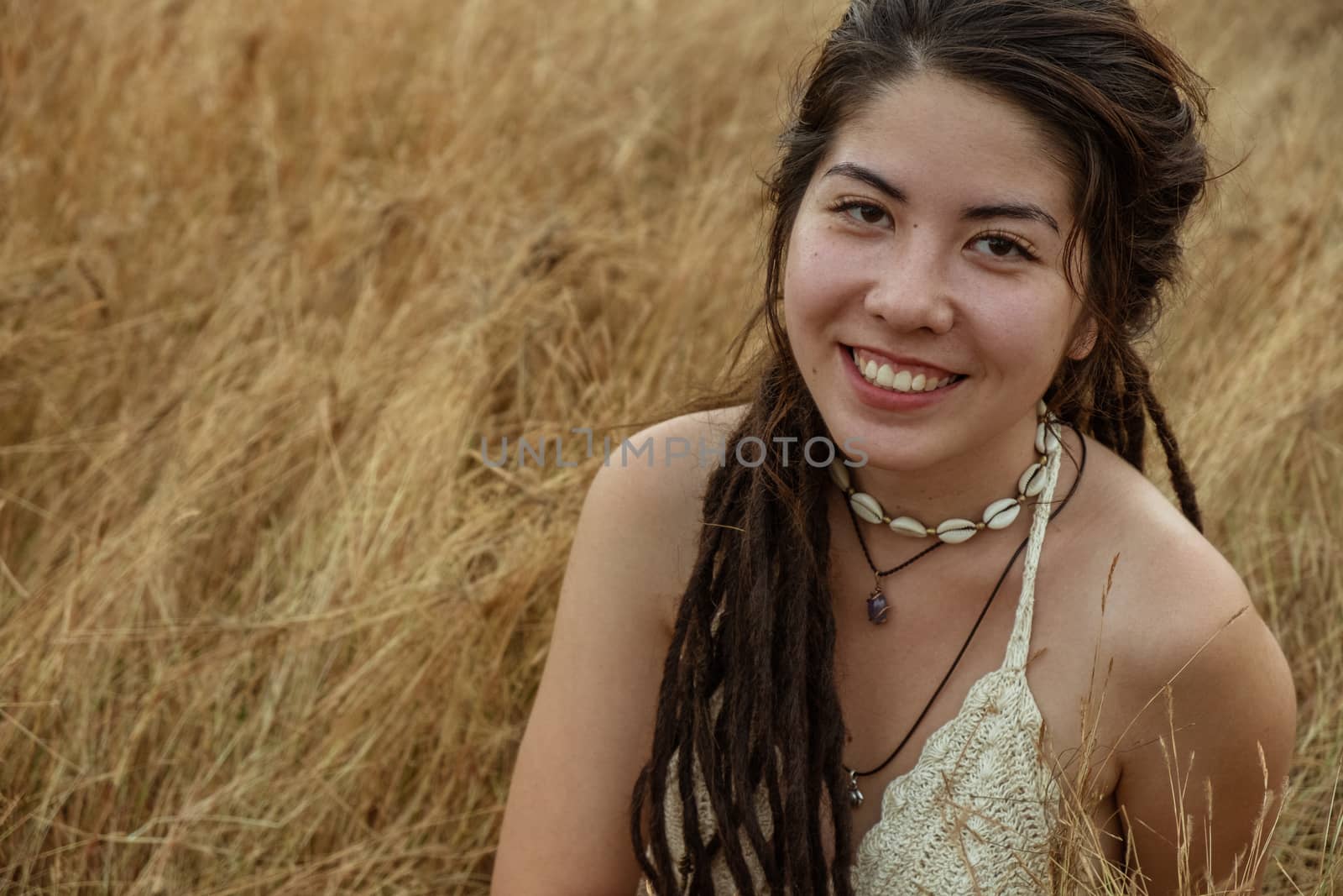 Young Woman Sitting On Dry Grass by snep_photo