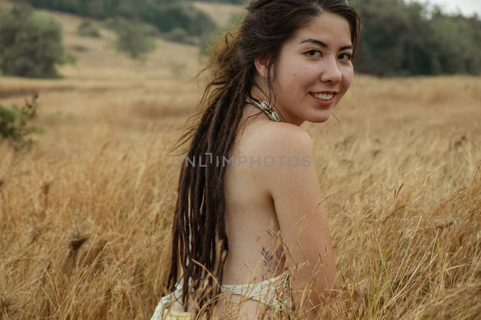 Young Woman Sitting On Dry Grass by snep_photo