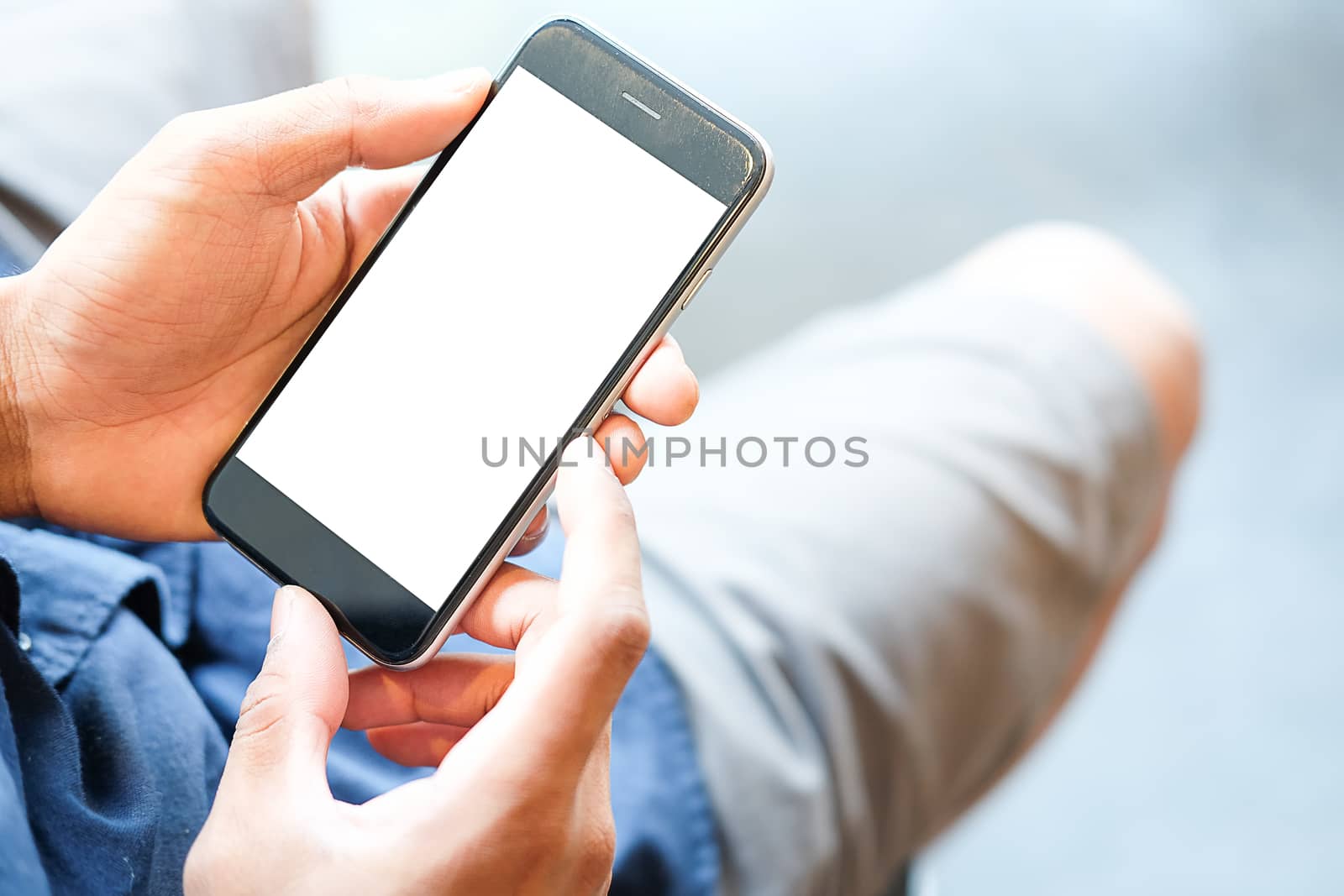 Cropped shot view of man hands holding smart phone with blank copy space screen for your text message or information content, female reading text message on cell telephone during in urban setting. 