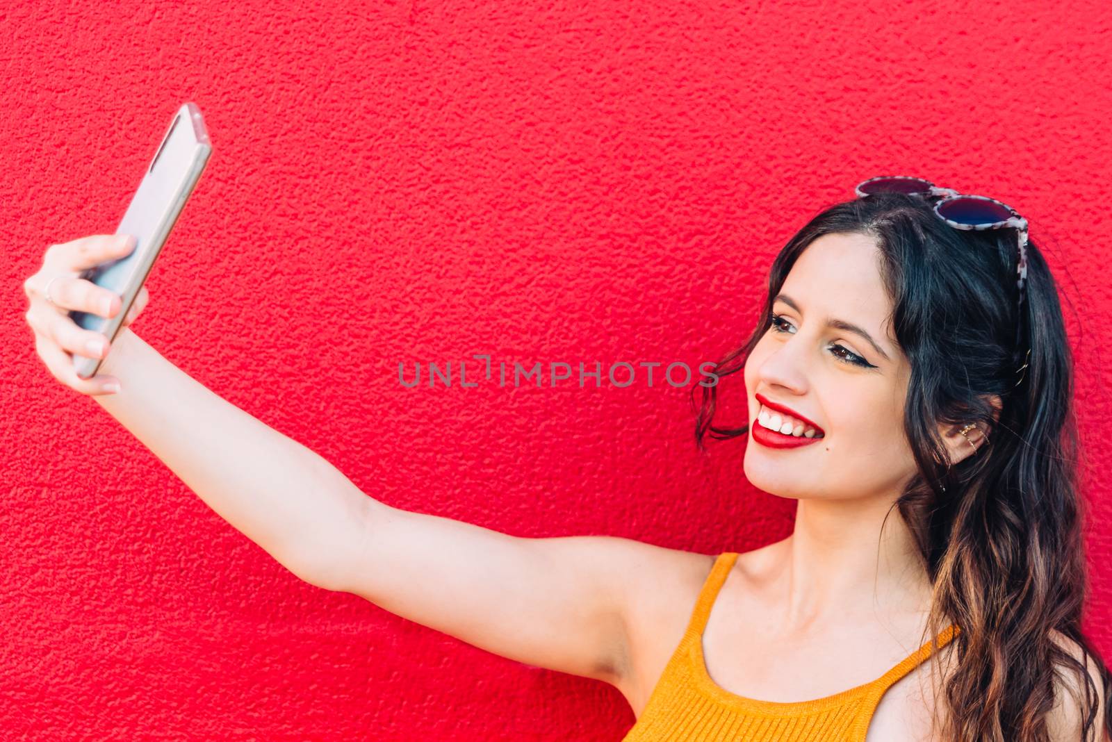 Portrait Of A Happy Young Woman Taking Selfie by Fotoeventis