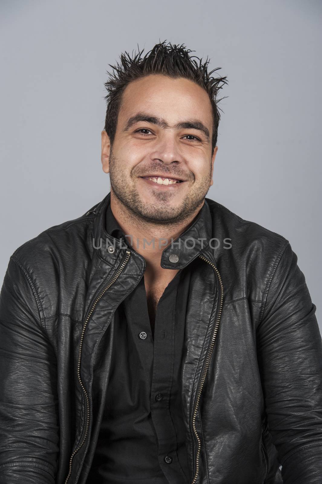 Portrait studio photo shoot of egyptian male man isolated on a blue background
