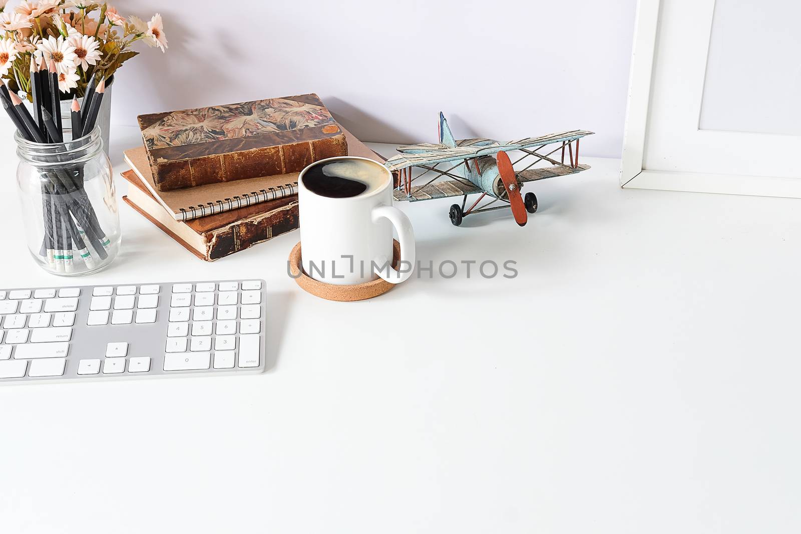 Top view office stuff with notepad, laptop and coffee cup mouse notepad shot.blank screen mobile phone and supplies on white desk workspace and copy space.