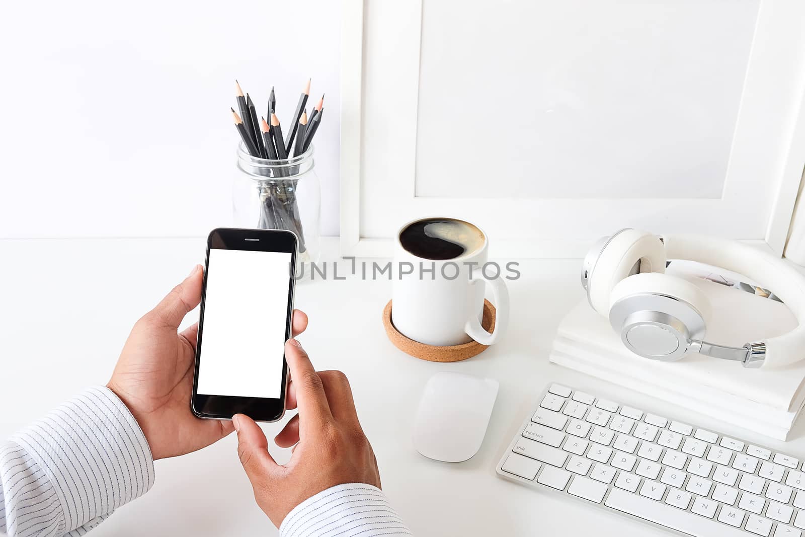 Cropped shot view of man hands holding smart phone with blank copy space screen for your text message or information content, female reading text message on cell telephone during in urban setting. 
