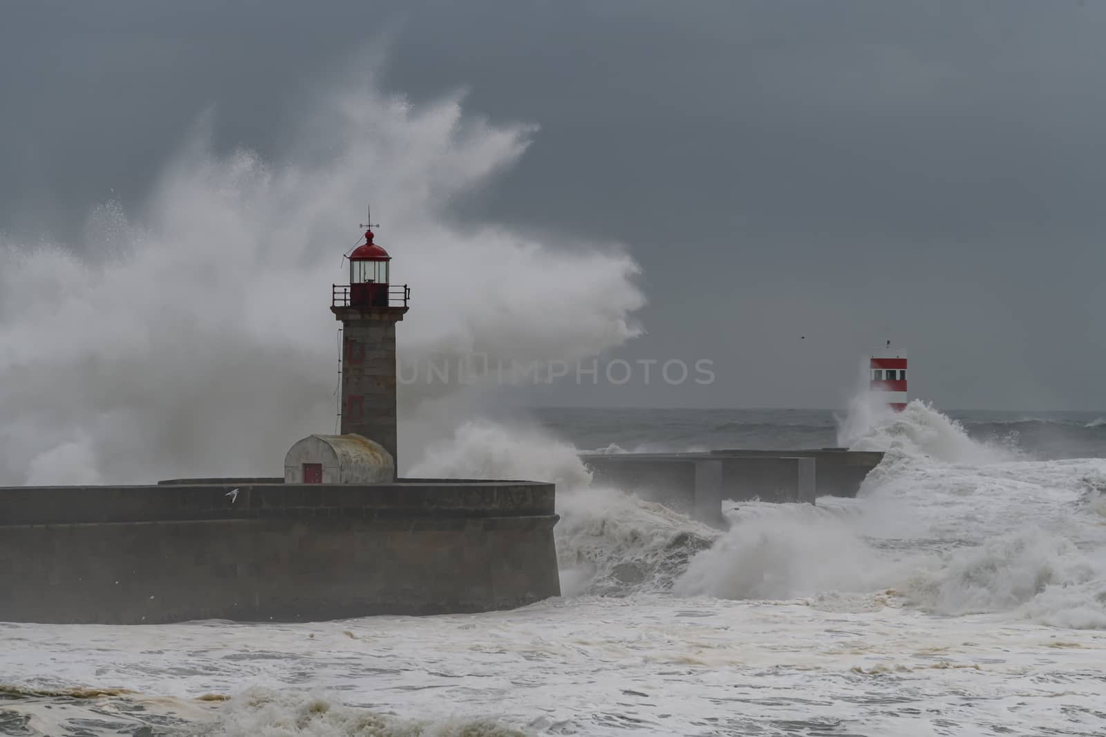 Waves crashing over Porto Lighthouse in a storm