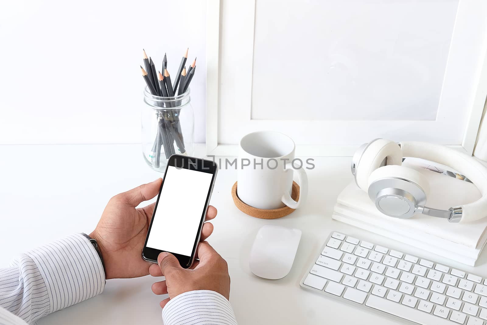 Cropped shot view of man hands holding smart phone with blank copy space screen for your text message or information content, female reading text message on cell telephone during in urban setting.