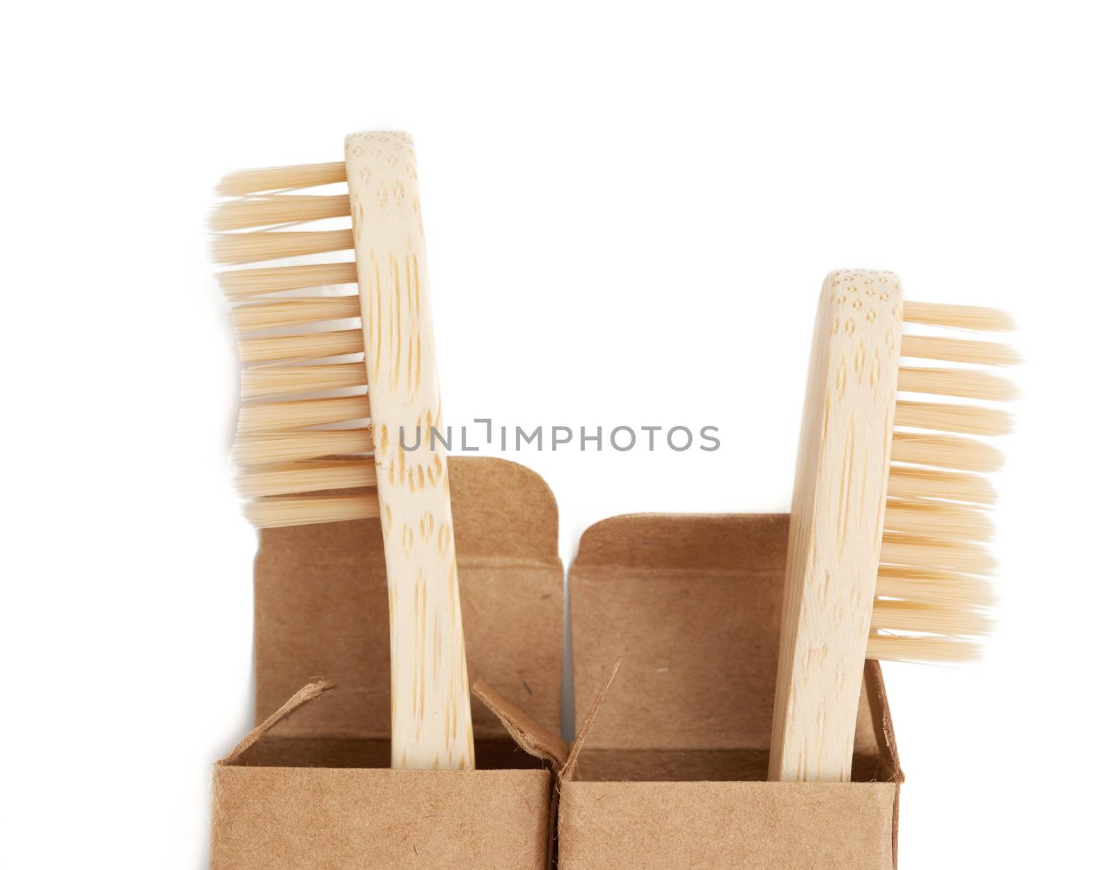 two wooden toothbrushes on a white background, plastic rejection concept, zero waste, close up