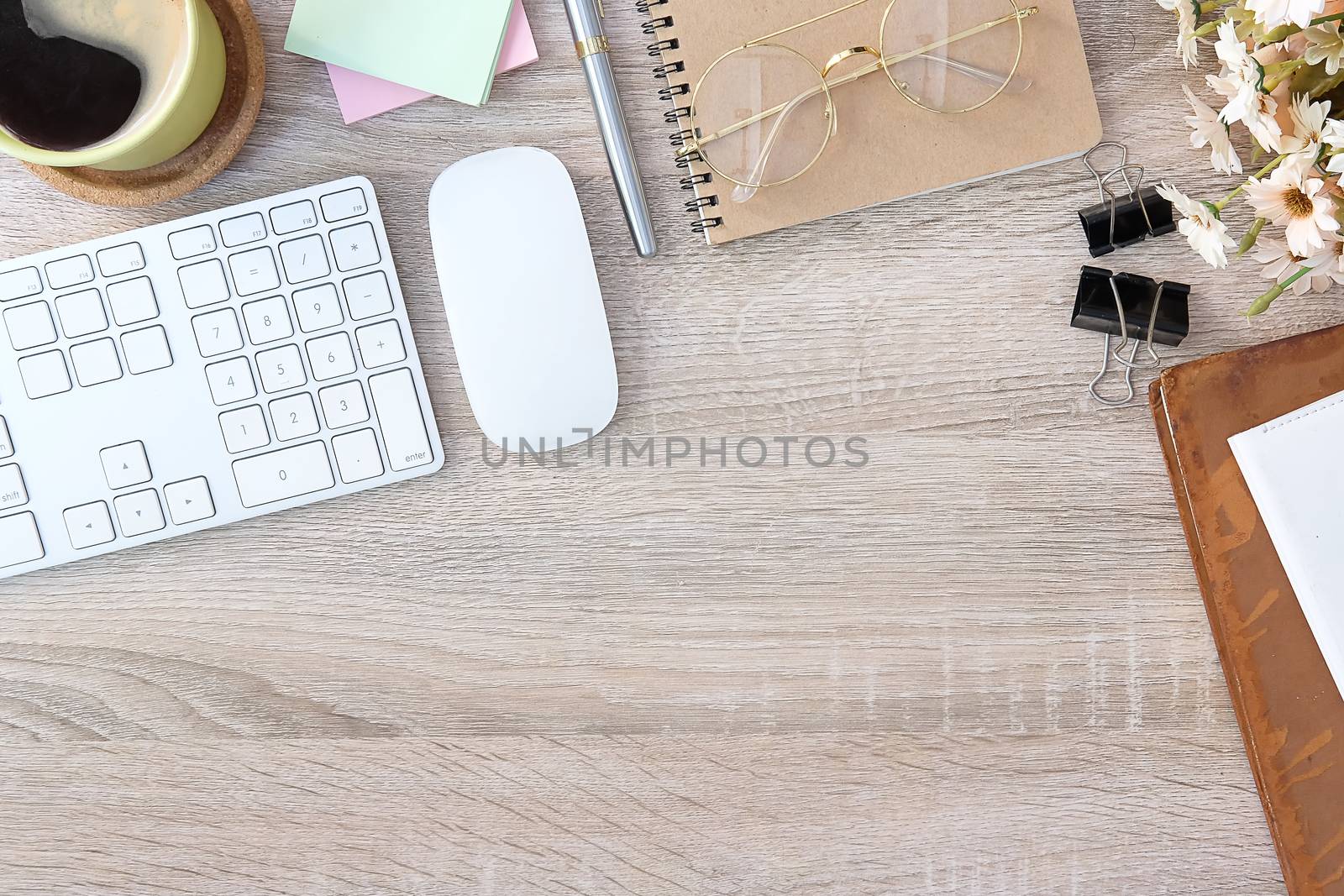 Top view office stuff with notepad, laptop and coffee cup mouse  by wattanaracha
