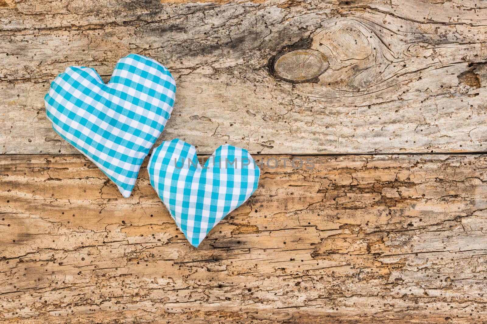 Light blue hearts on rustic old wooden background with copy space