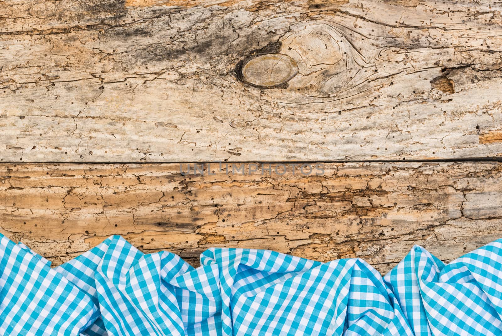 Vintage wooden table background rustic texture, with blue checkered tablecloth, high angel view