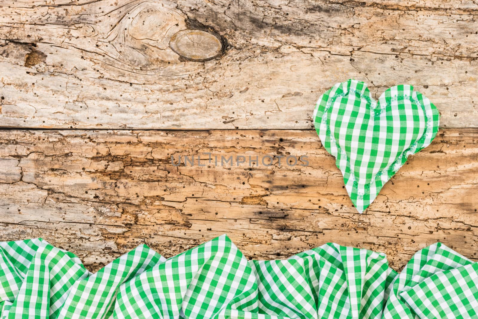 Rustic background with green heart on vintage wood with copy space