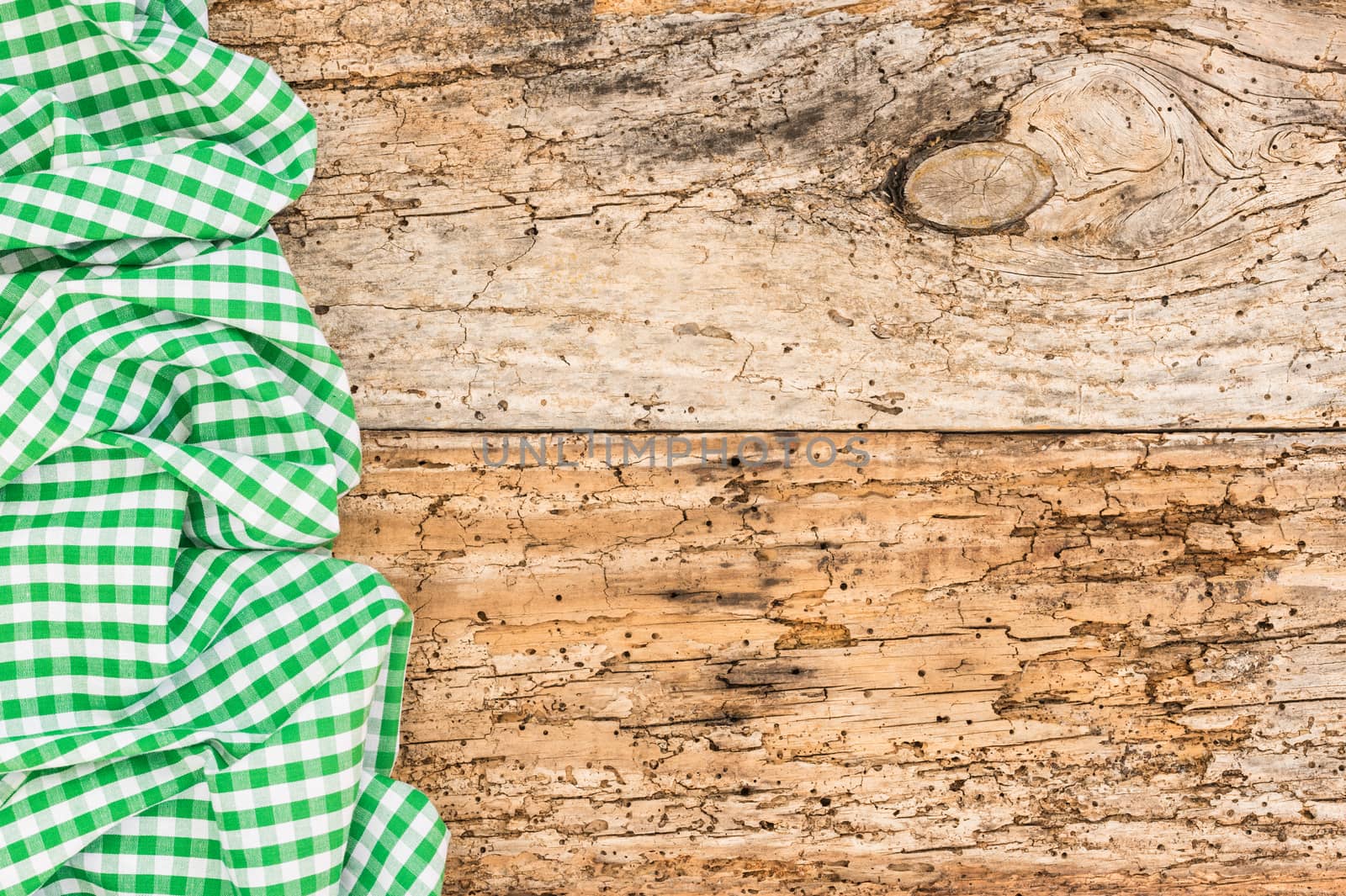 Old wooden table background rustic texture, with green checkered tablecloth, high angel view