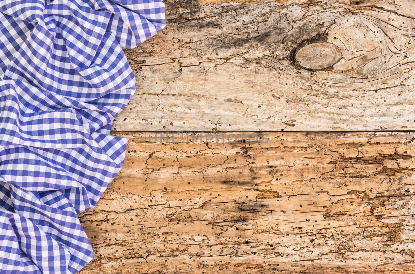 Wooden table background rustic texture, with blue checkered tablecloth, high angel view