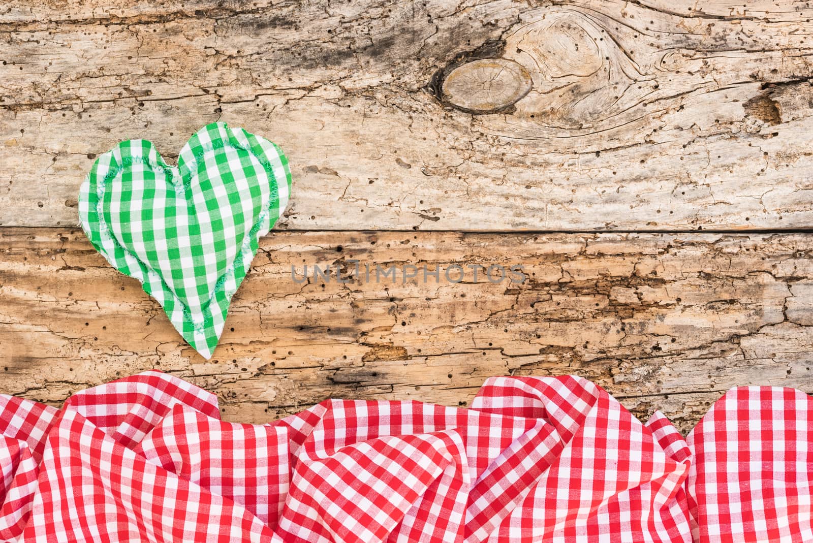 Green rustic heart on vintage wood background with copy space