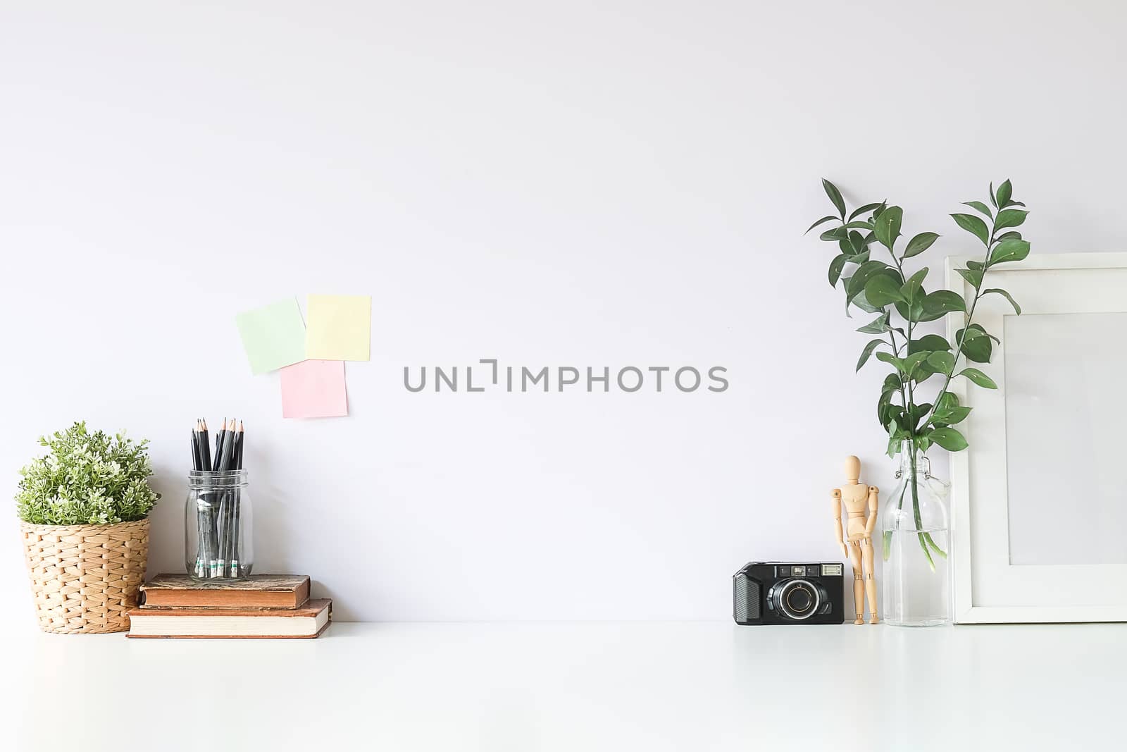 Mockup workspace desk and copy space books,plant and coffee on w by wattanaracha