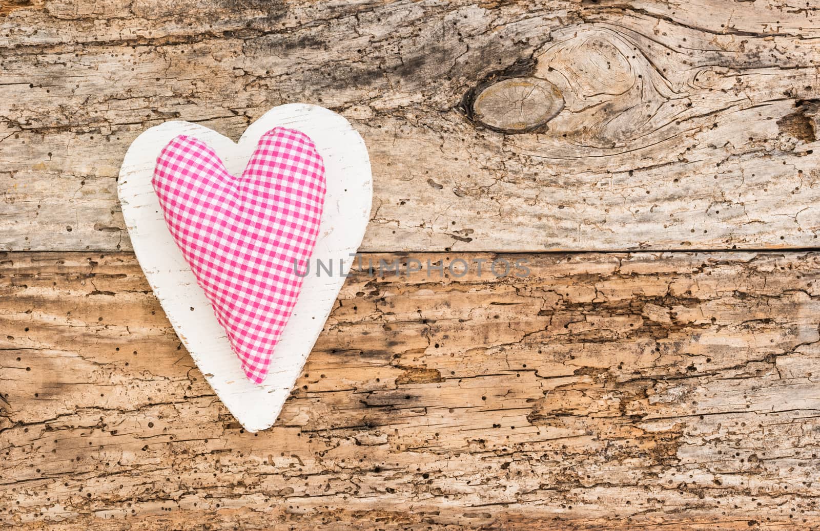 Romantic pink heart on rustic old wooden background for Valentine card with copy space

