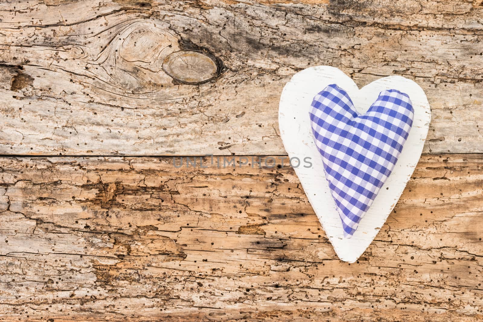 Blue heart on rustic old wooden background with copy space