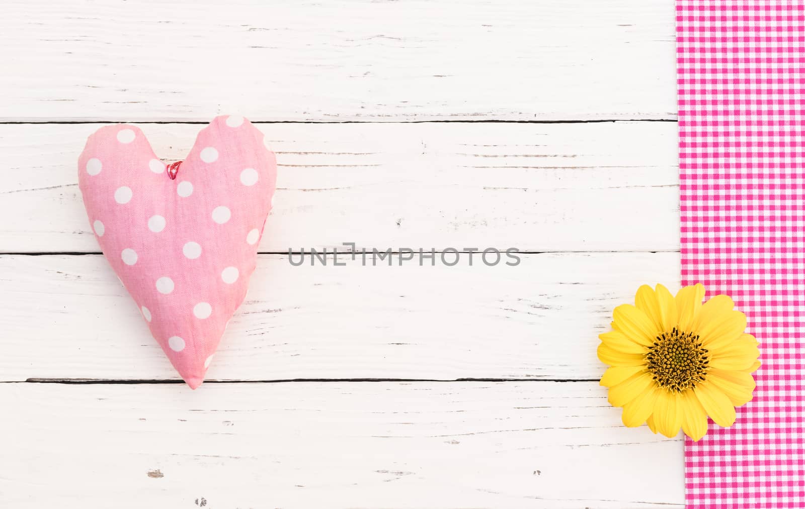 Cute pink heart and blossom on white wooden background with copy space