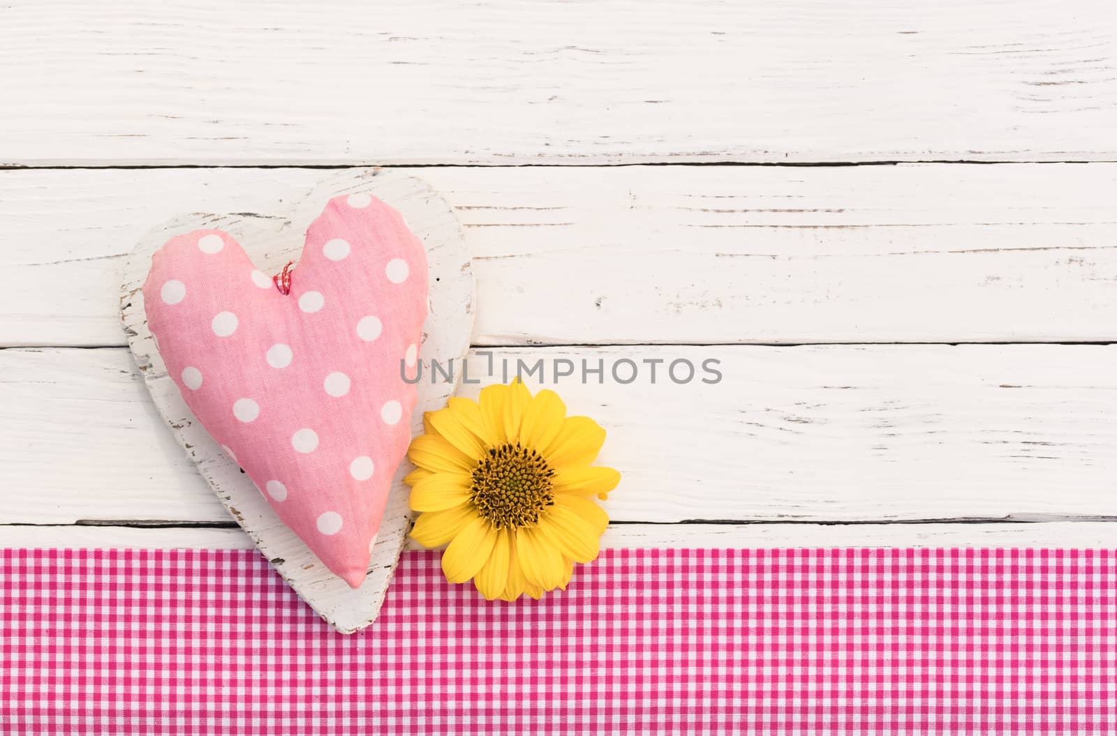 Cute pink heart with blossom on white wood background with copy space