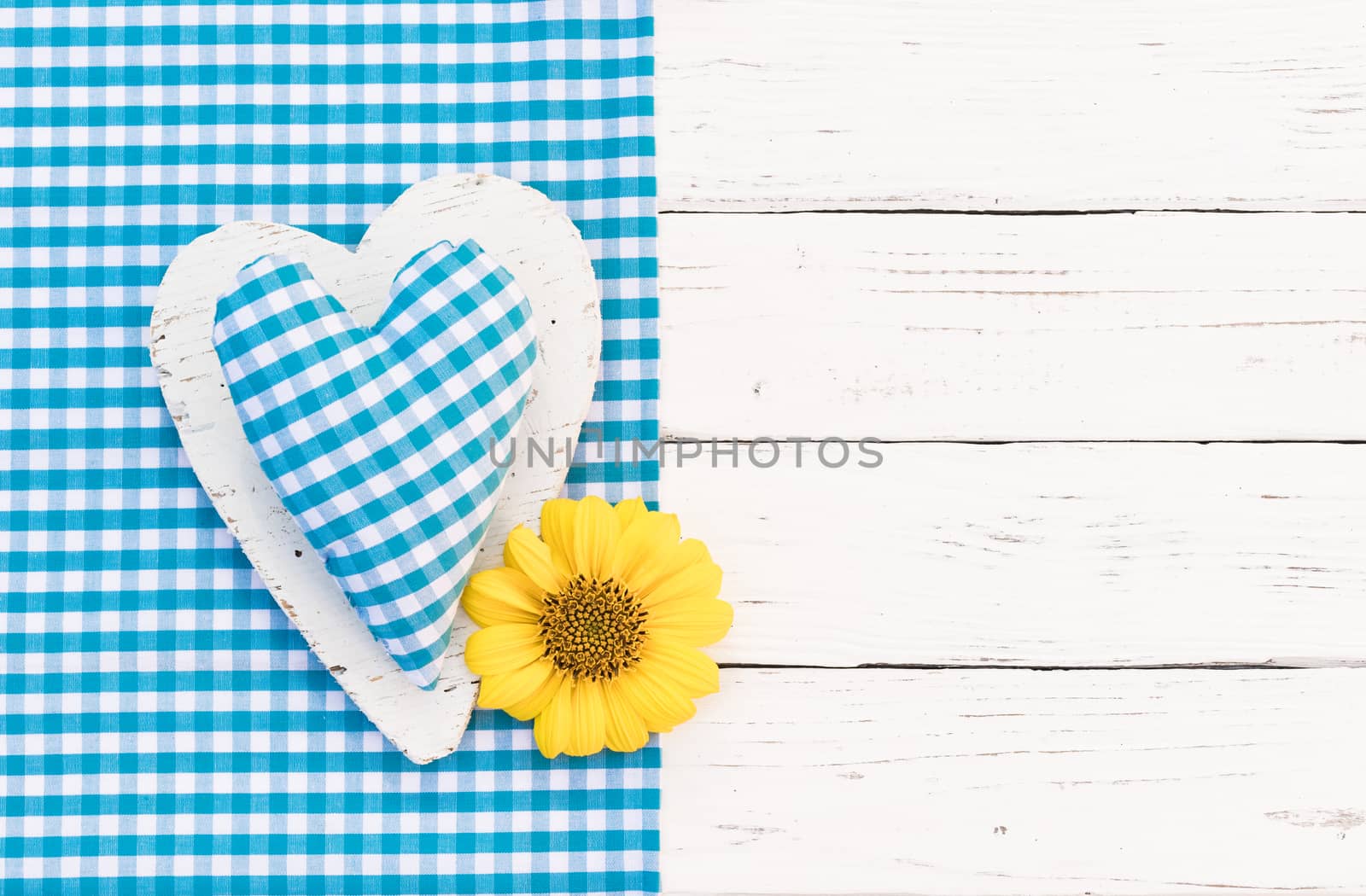 Cute blue heart and blossom on white wooden background with copy space

