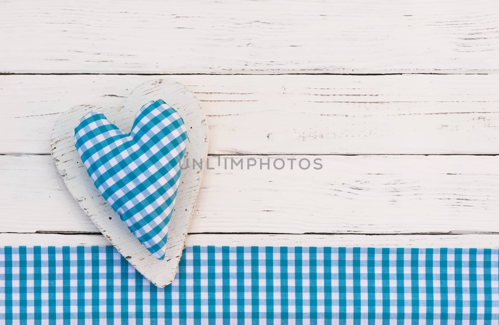 Cute blue heart on white wooden background and copy space