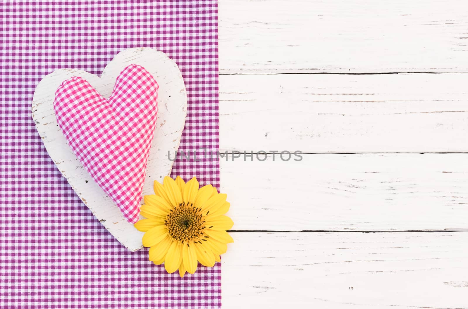 Romantic pink heart with yellow flower on white wooden background with copy space