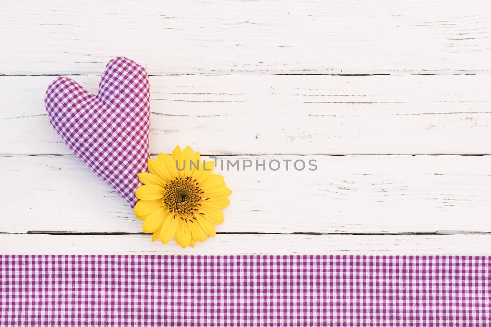 Rustic lilac heart with flower on white wood background with copy space