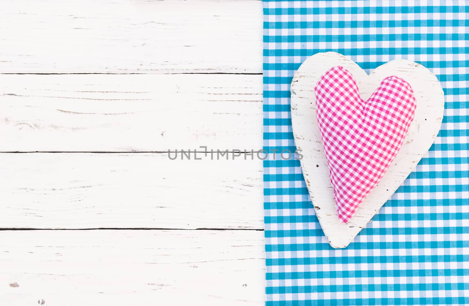 Pink heart decoration on white wood background by Vulcano